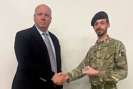 Musician Henry Newton has been presented with the Household Division Bands Commanding Officer’s Coin by Lieutenant Colonel Stewart Halliday in recognition of his outstanding efforts in organising a truly special musical celebration concert.